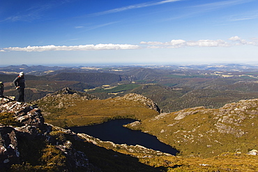 Black Bluff mountain tarn and hiker looking at view, Tasmania, Australia, Pacific