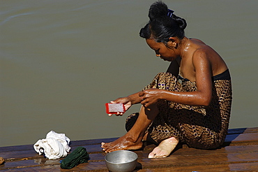 Woman washing, Indaign (Inthein), Inle Lake, Shan State, Myanmar (Burma), Asia