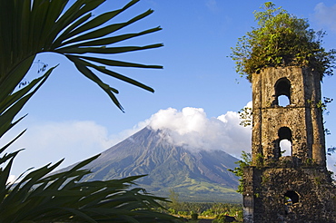 Church belfry ruins and volcanic cone with smoke plume of Mount Mayon, 2462m, Cagsawa, where 1200 people were buried alive in 1814 eruption, Bicol Province, Luzon Island, Philippines, Southeast Asia, Asia