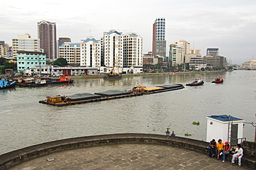 Barge on River Pasig with city skyline behind, Manila, Philippines, Southeast Asia, Asia