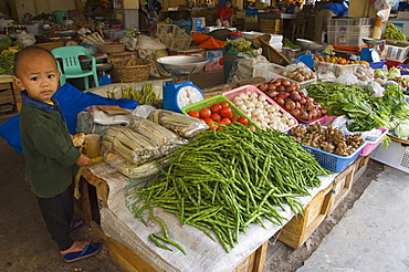 Little boy vendor at vegetable stall in food market, Bontoc, The Cordillera Mountains, Mountain Province, Luzon, Philippines, Southeast Asia, Asia