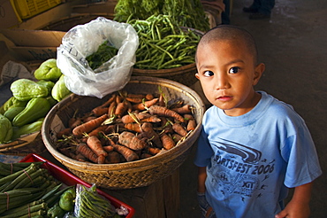 Little boy vendor at vegetable stall in food market, Bontoc, The Cordillera Mountains, Mountain Province, Luzon, Philippines, Southeast Asia, Asia