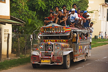 Jeepney truck with passengers crowded on roof, Coron Town, Busuanga Island, Palawan Province, Philippines, Southeast Asia, Asia