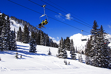 A chair lift carries skiers at Alta, one of the only resorts in America for skiers only, Alta Ski Resort, Salt Lake City, Utah, United States of America, North America