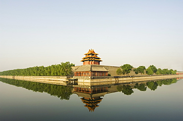 A reflection of a palace wall tower surrounded by the moat of The Forbidden City Palace Museum, UNESCO World Heritage Site, Beijing, China, Asia