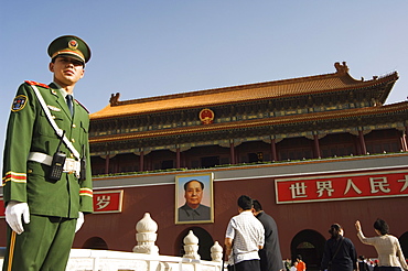 A soldier standing guard in front of a portrait of Mao Zhe Dong on the Gate of Heavenly Peace built in the 15th century on the edge of Tiananmen Square, Beijing, China, Asia