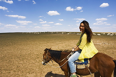 Chinese girl horseriding, Xilamuren grasslands, Inner Mongolia province, China, Asia