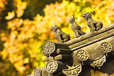 Autumn colours and ornamental Chinese style decorative figures on a pavilion in Ritan Park, Beijing, China, Asia