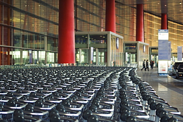 Hundreds of trolleys at Beijing Capital Airport, part of the new Terminal 3 building opened February 2008, second largest building in the world, Beijing, China, Asia