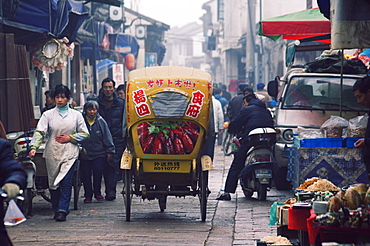 A decorated tricycle riding through the old streets of Suzhou, Jiangsu Province, China, Asia