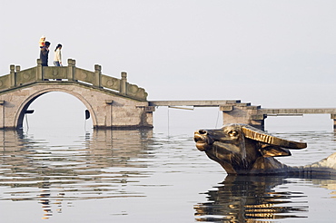 Statue of a golden water buffalo in the waters of West Lake, Hangzhou, Zhejiang Province, China, Asia