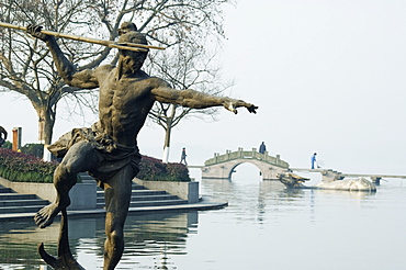 Statue of a spear fisherman in the waters of West Lake, Hangzhou, Zhejiang Province, China, Asia