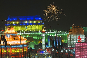 Fireworks over ice sculptures illuminated at night at the Ice Lantern Festival, Harbin, Heilongjiang Province, Northeast China, China, Asia