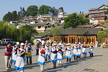 Naxi women dancing in Lijiang Old Town, UNESCO World Heritage Site, Yunnan Province, China, Asia