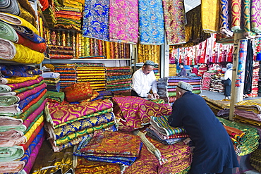 Silk fabrics being sold at the Sunday market, Kashgar (Kashi), Xinjiang Provice, China, Asia