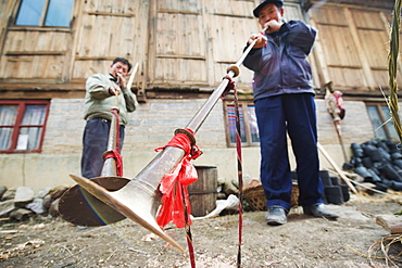 Men playing traditional horn instruments at a Lunar New Year festival in the Miao village of Qingman, Guizhou Province, China, Asia