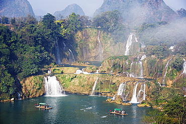 Tourist boats beneath Detian Falls, China and Vietnam transnational waterfall, Guangxi Province, China, Asia