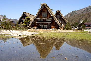 Reflection of gasshou zukuri thatched roof houses, Shirokawago, Ogimachi, Gifu prefecture, Honshu island, Japan, Asia