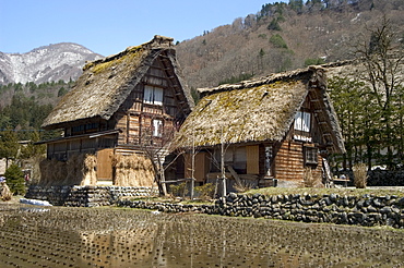 Reflection of gasshou zukuri thatched roof houses, Shirokawago, Ogimachi, Gifu prefecture, Honshu island, Japan, Asia