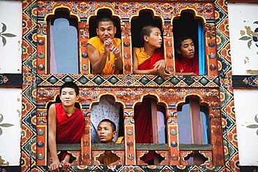 Young monks at a window, Chimi Lhakhang dating from 1499, Temple of the Divine Madman Lama Drukpa Kunley, Punakha, Bhutan, Asia