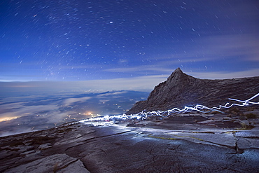 Stars and torch lights illuminating hiking trail, Kinabalu National Park (4095m), Sabah, Borneo, Malaysia, Asia