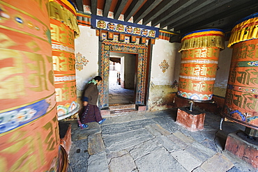 Woman spinning a prayer wheel, Jambay Lhakhang, built 659 by Tibetan King Songtsen Gampo, Jakar, Bumthang, Chokor Valley, Bhutan