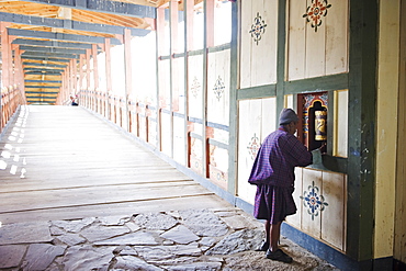 Local man spinning a prayer wheel, Punakha Dzong dating from 1637, Punakha, Bhutan, Asia