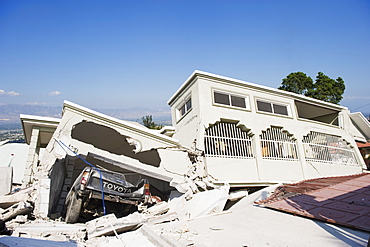 Damaged car and buildings, January 2010 earthquake, Montana Estate, Port au Prince, Haiti, West Indies, Caribbean, Central America