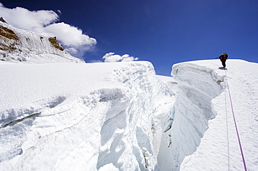 Mountain guide traversing a crevasse, Island Peak, 6189m, Solu Khumbu Everest Region, Sagarmatha National Park, Himalayas, Nepal, Asia