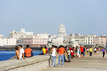 People walking on The Malecon, Capitolio and city skyline, Havana, Cuba, West Indies, Caribbean, Central America