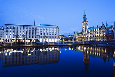 Rathaus (City Hall) illuminated at night reflected in a canal, Hamburg, Germany, Europe