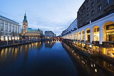 Rathaus (City Hall) illuminated at night reflected in a canal, Hamburg, Germany, Europe