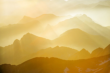 Mountains silhouetted at sunrise, view from Pico de Aneto, at 3404m the highest peak in the Pyrenees, Spain, Europe