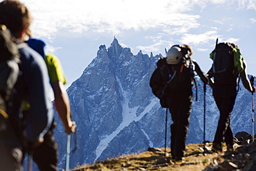 Hikers on Mont Blanc against mountain backdrop of Aiguille du Midi, Chamonix, French Alps, France, Europe