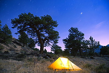 Tent illuminated under the night sky, Rocky Mountain National Park, Colorado, United States of America, North America