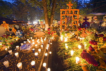 A candle lit grave, Dia de Muertos (Day of the Dead) celebrations in a cemetery in Tzintzuntzan, Lago de Patzcuaro, Michoacan state, Mexico, North America