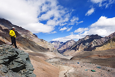 Hiker looking down to base camp, Plaza de Mulas, Aconcagua Provincial Park, Andes mountains, Argentina, South America