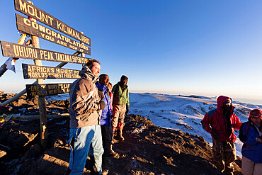 Climbers at summit sign and views on Mount Kilimanjaro, Kilimanjaro National Park, UNESCO World Heritage Site, Tanzania, East Africa, Africa