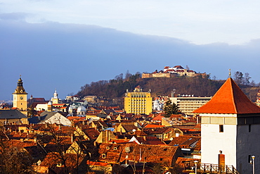 Church tower and old town houses below the citadel, Brasov, Romania, Europe