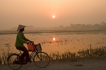 Bicycle in the morning mist at sunrise, limestone mountain scenery, Tam Coc, Ninh Binh, south of Hanoi, North Vietnam, Southeast Asia, Asia