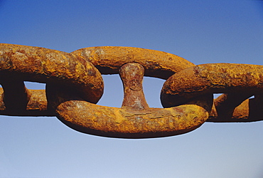 Close-up of a rusty anchor chain of a container ship