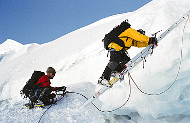 Crossing crevasse when climbing Huayna Potosi, Cordillera Real, Bolivia, South America