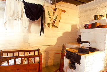 Stove and cot in living room of traditional house, Vlkolinec village, UNESCO World Heritage Site, in Velka Fatra Mountains, Vlkolinec, Velka Fatra, Slovakia, Europe