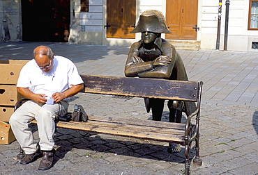 Man on park bench and statue of Napoleon, Hlavne Square, Bratislava, Slovakia, Europe