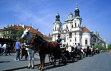 Horse drawn carriage at Old Town Square and St. Nicholas church, Stare Mesto, Prague, Czech Republic, Europe