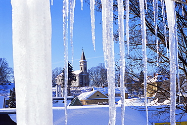 Catholic church in village of Luceny nad Nisou, Jizerske mountains, seen through icicles, Luceny nad Nisou, Liberecko, Czech Republic, Europe