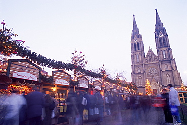 Christmas decoration at market on namesti Miru (Square) and neo-Gothic St. Ludmilla Church at twilight, Vinohrady, Prague, Czech Republic, Europe