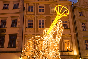 Illuminated angel against Baroque house facades, part of Christmas decorations, Staromestske (Old Town Square), Stare Mesto, Prague, Czech Republic, Europe