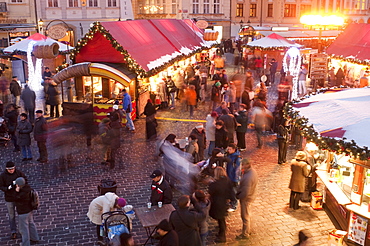 Stalls and people at Christmas Market at dusk, Old Town Square, Stare Mesto, Prague, Czech Republic, Europe