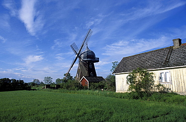 Landscape with wooden windmill and two houses in the village of Kvarnbacken, Oland Island, Sweden, Scandinavia, Europe